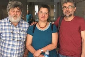 Şebnem Korur Fincancı, Erol Önderoğlu, and Ahmet Nesin posing after their court hearing