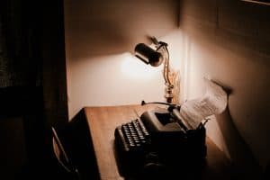 typewriter and lamp on a desk