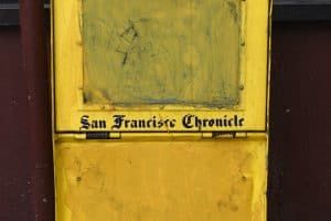 A decommissioned or defaced San Francisco Chronicle newspaper box painted yellow and abandoned in an alley in San Francisco, California. (Photo by Robert Alexander/Getty Images)