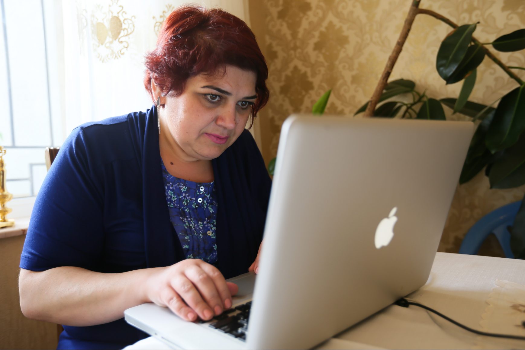 Khadija Ismayilova sits at a computer
