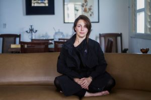 tania bruguera seated on couch