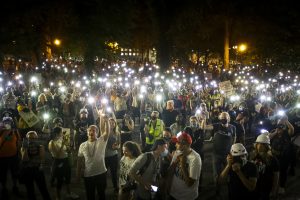Demonstrators gathered at a Portland Black Lives Matter protest raising their cell phone lights