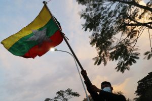 Protester waving a Myanmar flag