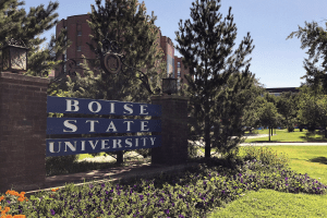 sign that reads Boise State University amid bushes and trees
