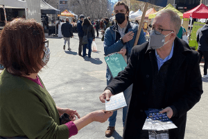 Scott Stringer handing a campaign flyer to a constituent