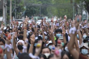 large group of protesters raising sign of resistance in Yangon, Myanmar