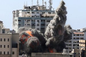 smoke billows from a building in Gaza