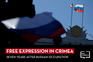 Russian and Crimean flags fly over a local government building in Simferopol, Ukraine; on top, text reads: "Free Expression in Crimea: Seven Years After Russian Occupation"
