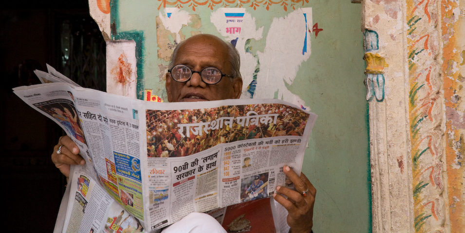 Man reading a Rajasthan newspaper about internet shutdowns in Jammu and Kashmir