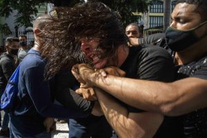 Cuban protester being held by police