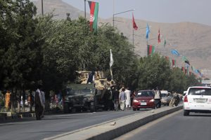 image of Kabul street with vehicles and flags