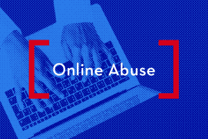 Hands typing on a laptop; on top: “Online Abuse”
