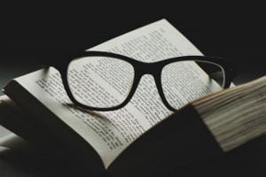 Open book with glasses on the page