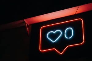 neon sign of a like button with zero likes