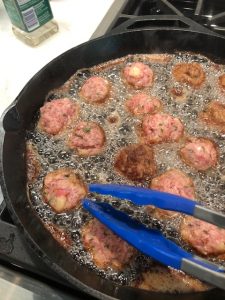 meatballs cooking in a pan