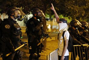 Riot police block off the Albuquerque Convention Center to anti-Trump protests