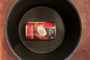 Can of coconut milk in a pot