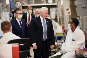 Vice President Mike Pence speaking to a researcher while touring COVID-19 research facilities at the Mayo Clinic