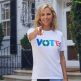 Tory Burch pointing at the camera, wearing a t-shirt that says “VOTE”