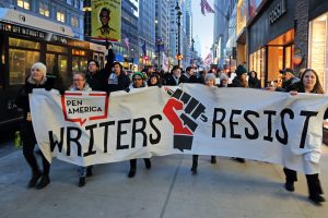 Participants hold PEN America’s Writers Resist banner, marching in New York City