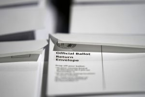 stacks of ballot return envelopes