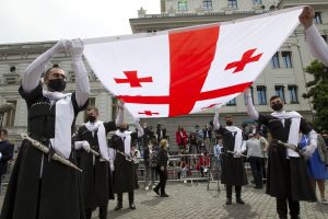 image showing men holding the Georgian flag