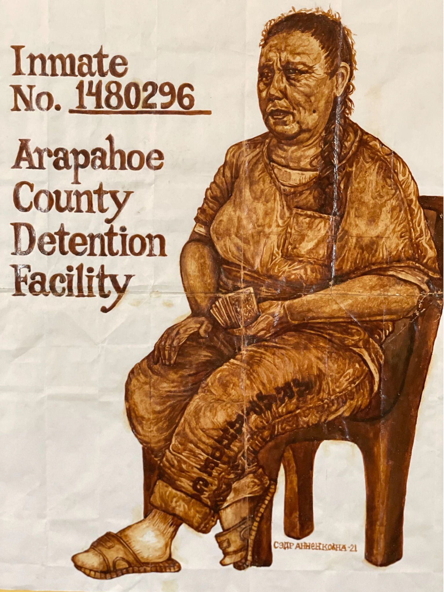 Portrait of a woman sitting in a chair holding money in her hand. She sits besides text that reads, "Inmate NO. 1480296 Arapohoe County Dentention Facilty"