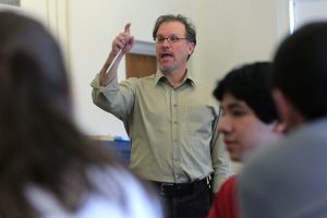 A college professor giving a lecture in a classroom