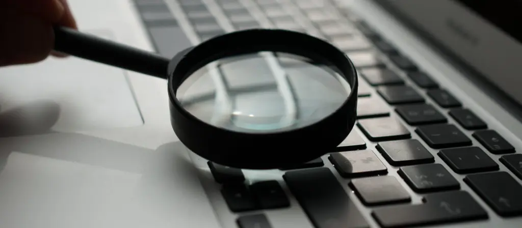 Magnifying glass over a computer keyboard