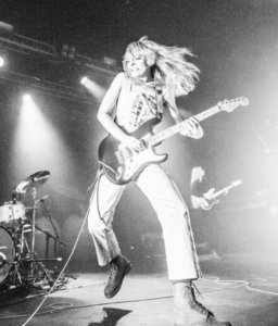 Clementine Creevy playing guitar at a performance