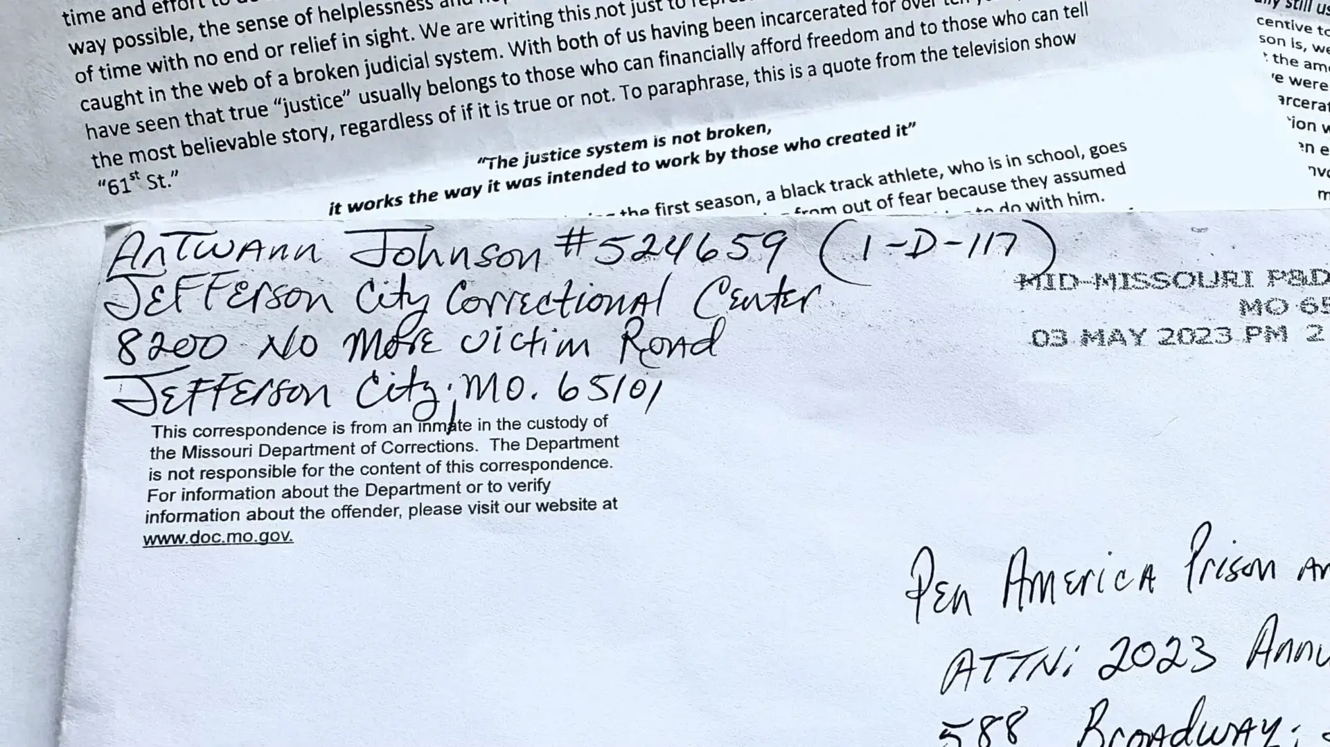 A close-up photo of a handwritten envelope for Latwan Johnson at Jefferson City Correctional Center, 8200 No More Victim Road, MO 65101, captures the personal touch of prison letters mail. Another letter peeks from underneath.
