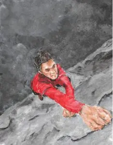 From a bird’s eye view, an African American man holds onto the edge of a rocky cliff