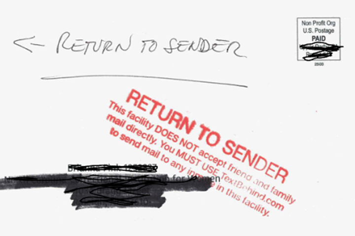 Close-up of a letter with a black marker on it.