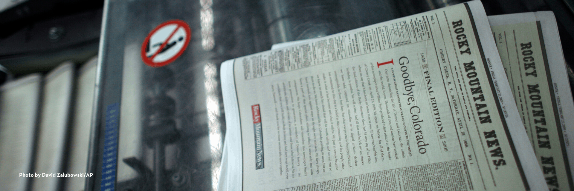 A close-up of the final edition of the Rocky Mountain News newspaper with the headline Goodbye, Colorado, lying on a conveyor belt in a printing facility, highlights why many choose to donate to PEN America to support press freedom.
