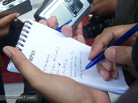 A reporter taking notes