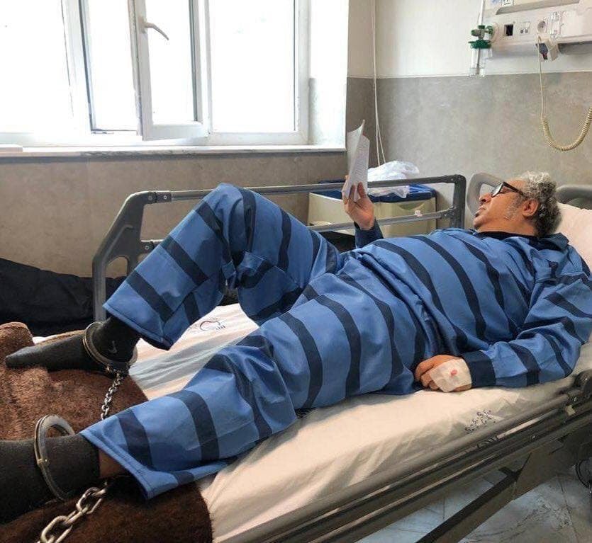 Poet Baktash Abtin shown shackled to his prison bed.