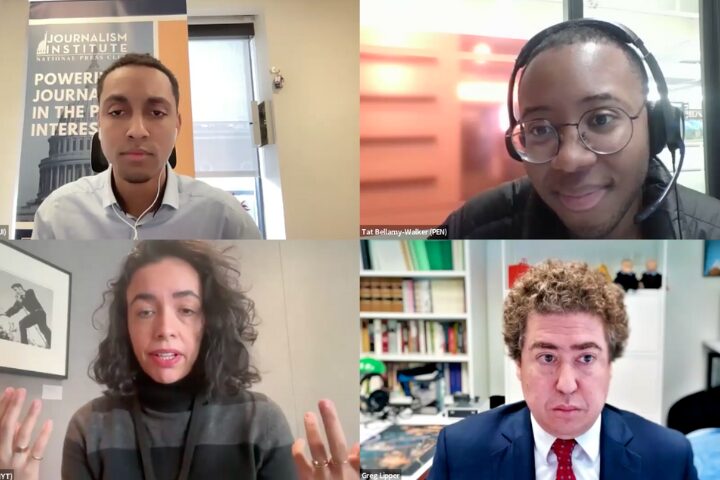 Four people participating in a virtual meeting. A Journalism Institute banner is visible in one participants background. They are engaged, with some using gestures. Books and office materials are in the background.