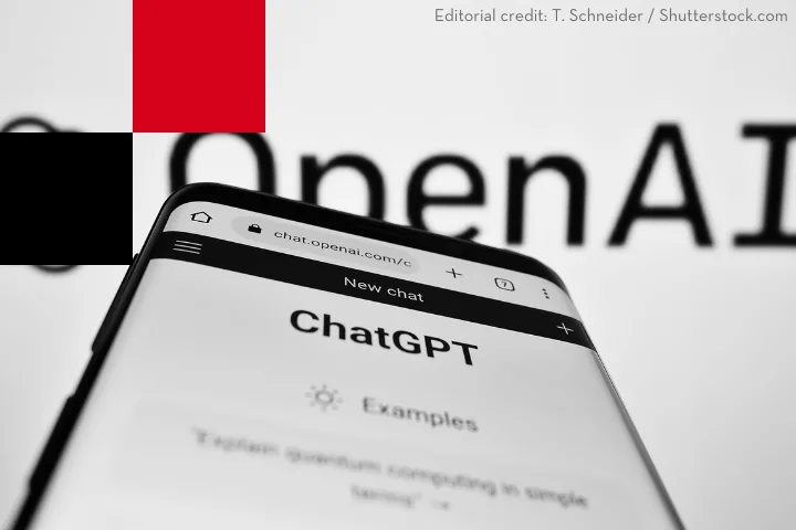 Smartphone screen displaying the ChatGPT webpage in a browser, with the OpenAI logo blurred in the background. Editorial credit to T. Schneider of Shutterstock.