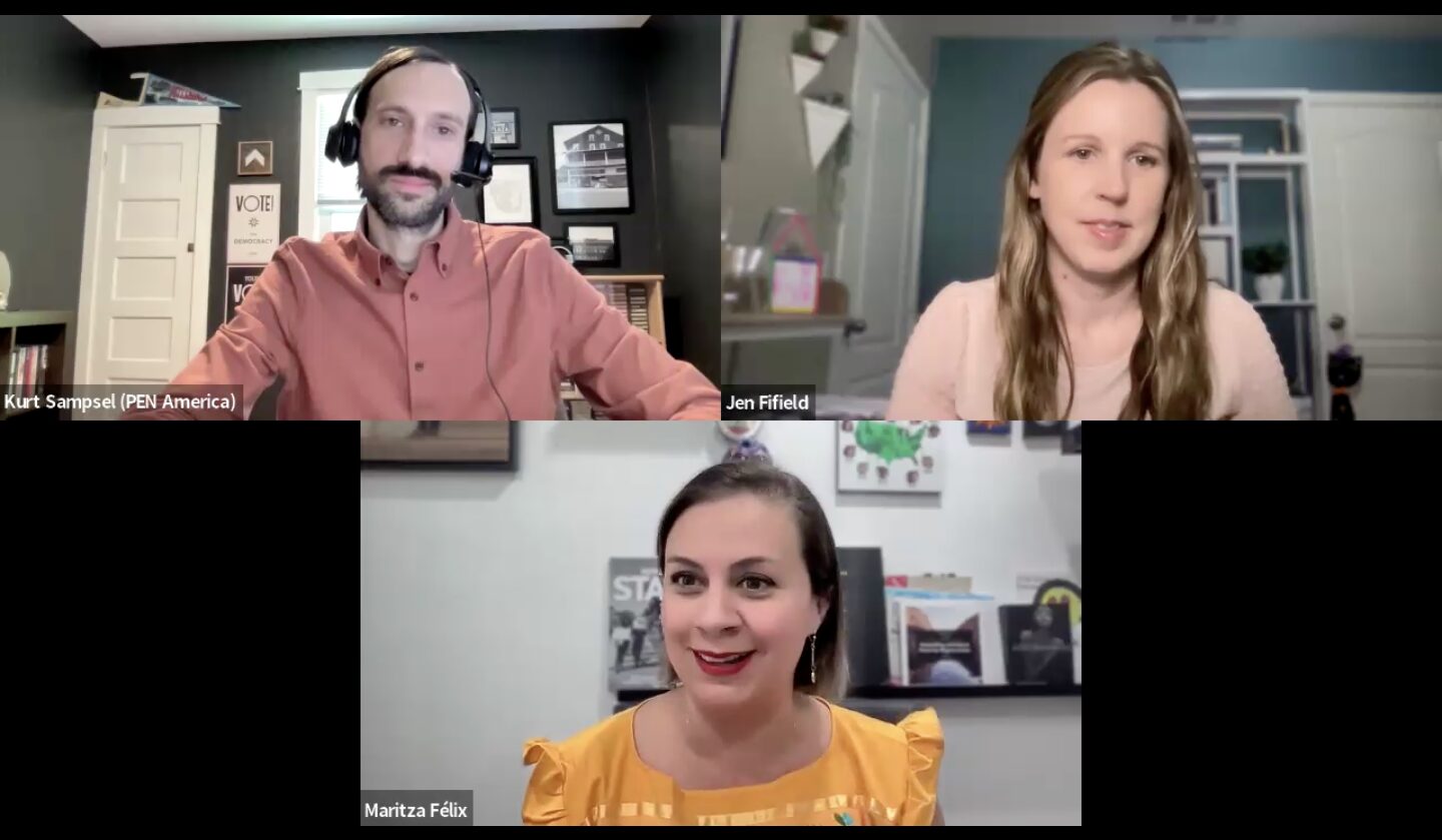 Three people are in a virtual meeting. The top left person is wearing a headset and a red shirt; the top right person has long hair and a headset. The bottom center person is wearing a yellow top with colorful patterns. Books and photos are in the background.