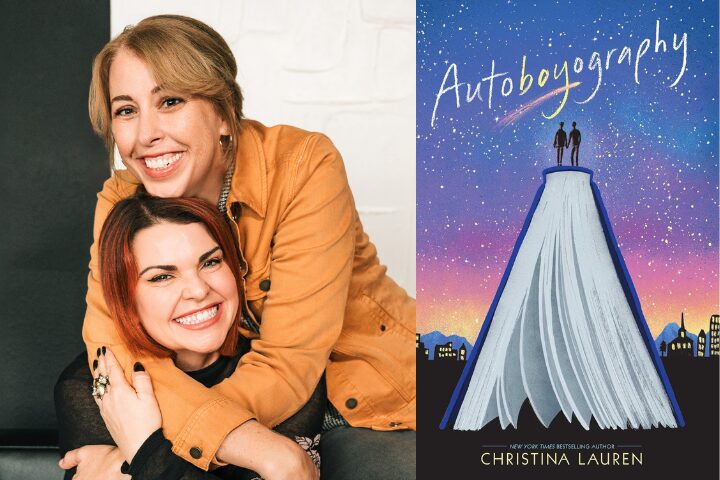 Two smiling women, one hugging the other from behind, sit next to the cover of the book “Autoboyography” by Christina Lauren, which depicts two figures standing on an open book against a starry sky.