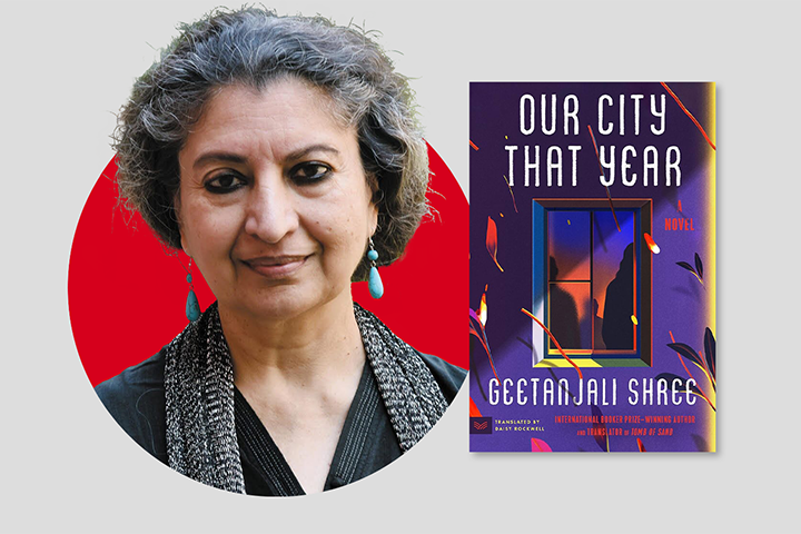 A person with short curly gray hair stands beside a book titled Our City That Year by Geetanjali Shree. The book cover features a stylized window with abstract red and purple shapes. The background is a red circle on a gray backdrop.