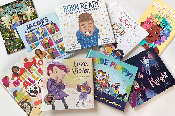 A collection of ten colorful childrens books with diverse themes and characters, including titles like Born Ready, Intersection Allies, Love, Violet, RIDE PUPPY!, and Jacob’s Room to Choose, arranged on a white surface.