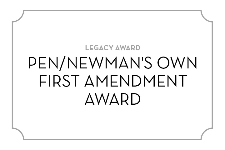 A white placard with a thin gray border displays the text: LEGACY AWARD PEN/NEWMANS OWN FIRST AMENDMENT AWARD in bold, black, and gray capital letters.