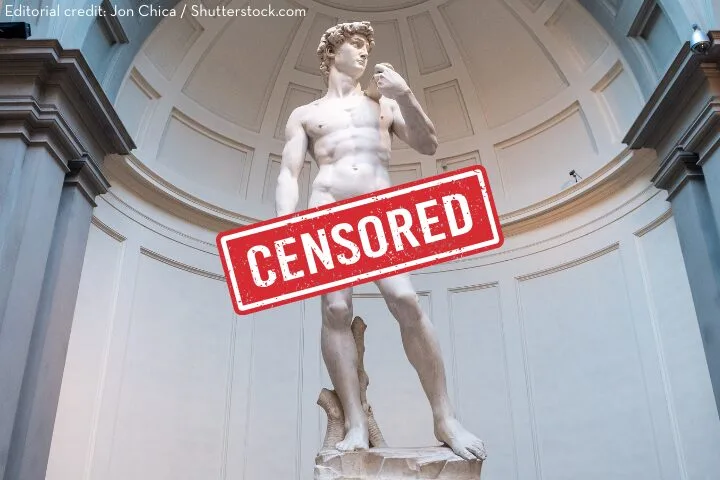 Michelangelos statue of David stands in a museum alcove. A red CENSORED stamp covers the lower part of the statue. Image credit is given to Jon Chica/Shutterstock.com in the top left corner.